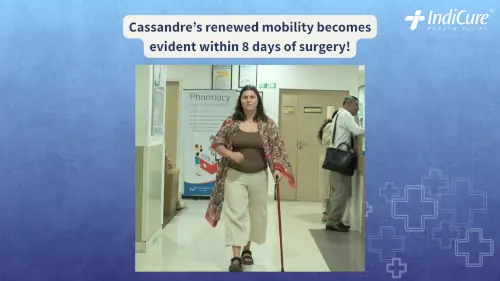 Cassandre Guinet, an NZ patient, walking confidently with a cane in the hospital hallway just days after her successful double hip replacement surgery in India.